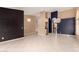 Spacious living area featuring tile floors, two-tone walls, modern light fixtures, and a convenient wet bar at 1590 W Desert Broom Dr, Chandler, AZ 85248