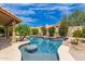 Beautiful pool with a unique design and landscaping, offering a serene and private backyard oasis at 1590 W Desert Broom Dr, Chandler, AZ 85248