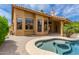 Inviting pool and spa with a tiled roofed patio, surrounded by lush landscaping, perfect for outdoor living at 1590 W Desert Broom Dr, Chandler, AZ 85248