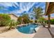 Scenic pool featuring mature trees, lush landscaping, and a small waterfall, creating a tranquil setting at 1590 W Desert Broom Dr, Chandler, AZ 85248
