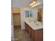 Elegant bathroom featuring double sinks with a spacious vanity and a large mirror at 15951 W Yavapai St, Goodyear, AZ 85338