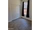 Cozy bedroom includes a window with dark curtains and a built-in closet at 15951 W Yavapai St, Goodyear, AZ 85338