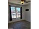Well-lit bedroom with a ceiling fan and a large window offering a neighborhood view at 15951 W Yavapai St, Goodyear, AZ 85338