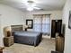 Inviting bedroom featuring neutral tones, a ceiling fan, and wood-look tile flooring at 15951 W Yavapai St, Goodyear, AZ 85338