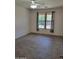 Bedroom featuring a large window providing natural light, ceiling fan, and tiled flooring at 15951 W Yavapai St, Goodyear, AZ 85338