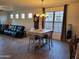 Open concept dining area with tile flooring, chandelier, and large windows for plenty of natural light at 15951 W Yavapai St, Goodyear, AZ 85338