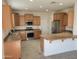 Well-equipped kitchen with stainless steel appliances, ample cabinetry, and granite countertops at 15951 W Yavapai St, Goodyear, AZ 85338