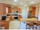 Well-equipped kitchen with stainless steel appliances, granite countertops, and a breakfast bar at 15951 W Yavapai St, Goodyear, AZ 85338