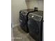 Laundry room featuring side-by-side, front-load, dark gray Samsung washer and dryer set at 15951 W Yavapai St, Goodyear, AZ 85338