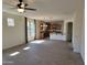 Open floor plan with tiled flooring connecting living room and kitchen, filled with natural light at 15951 W Yavapai St, Goodyear, AZ 85338