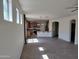 Open floor plan with tiled floors connecting living room and kitchen, filled with natural light at 15951 W Yavapai St, Goodyear, AZ 85338