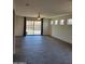 Bright living room featuring tiled floors, recessed lighting, and sliding glass doors at 15951 W Yavapai St, Goodyear, AZ 85338