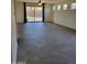 Spacious living room with tiled flooring, ceiling fan, and sliding glass doors leading to the backyard at 15951 W Yavapai St, Goodyear, AZ 85338