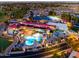 Aerial view of the community clubhouse with pool, golf course and tennis courts at dusk at 1642 E Palm Beach Dr, Chandler, AZ 85249
