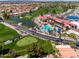 Aerial view of the community featuring a golf course, lake, pool and tennis courts at 1642 E Palm Beach Dr, Chandler, AZ 85249