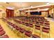 Spacious auditorium with seating arrangements, chandeliers, and a stage for performances at 1642 E Palm Beach Dr, Chandler, AZ 85249