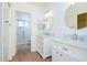 Bathroom with double sink vanity, marble countertops and flooring, and walk-in shower at 1642 E Palm Beach Dr, Chandler, AZ 85249