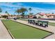 Outdoor bocce ball court featuring a pristine playing surface, benches, and well-manicured landscaping at 1642 E Palm Beach Dr, Chandler, AZ 85249