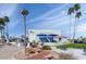 SunBird building featuring a welcoming outdoor seating area, landscaping, and bright blue awnings at 1642 E Palm Beach Dr, Chandler, AZ 85249