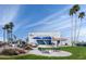 Exterior of the Sun Bird Golf Resort building with an outdoor patio, tall palm trees, and beautiful blue skies at 1642 E Palm Beach Dr, Chandler, AZ 85249