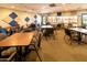 Bright game room featuring tables, chairs, and large windows offering views of the lush outdoors at 1642 E Palm Beach Dr, Chandler, AZ 85249