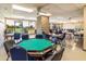 Bright game room equipped with tables, chairs, and ample natural light overlooking the golf course at 1642 E Palm Beach Dr, Chandler, AZ 85249