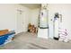 Garage space featuring a hot water tank, water softener, shelving and a door to the home at 1642 E Palm Beach Dr, Chandler, AZ 85249
