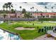 Scenic view of golfers on a well-maintained green with sand traps and water features, surrounded by palm trees at 1642 E Palm Beach Dr, Chandler, AZ 85249
