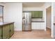 Bright kitchen with stainless steel fridge, wooden floors and a view to the living area at 1642 E Palm Beach Dr, Chandler, AZ 85249