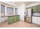 Eat-in kitchen area with stainless steel refrigerator, wooden floors, and a bay window at 1642 E Palm Beach Dr, Chandler, AZ 85249