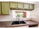 View of the sink and countertops in a well-lit kitchen with ample cabinet space at 1642 E Palm Beach Dr, Chandler, AZ 85249
