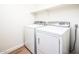 Bright laundry room features a white washer and dryer set and convenient shelf space at 1642 E Palm Beach Dr, Chandler, AZ 85249