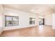 Bright living room featuring wood floors, large windows, and modern ceiling fan at 1642 E Palm Beach Dr, Chandler, AZ 85249
