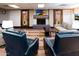 Relaxing lounge with a fireplace, comfortable seating, and unique artwork providing a cozy atmosphere at 1642 E Palm Beach Dr, Chandler, AZ 85249