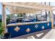 Outdoor kitchen and grilling area featuring a covered pergola, large grill, bar and views of the parking area at 1642 E Palm Beach Dr, Chandler, AZ 85249