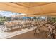 Outdoor seating area with folding chairs, tables and shade featuring a covered seating area next to pool and community center at 1642 E Palm Beach Dr, Chandler, AZ 85249