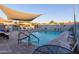 Community pool with a shade structure and chairs, surrounded by well-maintained paving stones at 1642 E Palm Beach Dr, Chandler, AZ 85249