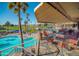 Charming poolside patio with comfortable seating and shade overlooking the sparkling pool and lush greenery at 1642 E Palm Beach Dr, Chandler, AZ 85249