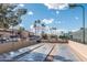 Recreational shuffleboard court with palm trees and a community building in the background at 1642 E Palm Beach Dr, Chandler, AZ 85249