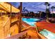 Outdoor pool area featuring a large pool with lighting and an adjacent jacuzzi for leisure at 1642 E Palm Beach Dr, Chandler, AZ 85249