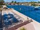 Elevated view of blue tennis and shuffleboard courts offers a comprehensive recreational area for community members at 1642 E Palm Beach Dr, Chandler, AZ 85249