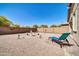 An artistic backyard with metal lawn ornaments surrounding a fountain feature, alongside a patio with a chaise lounge at 16593 W Alameda Rd, Surprise, AZ 85387