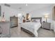 Spacious bedroom featuring a comfortable bed, dresser, and ensuite bathroom access at 16593 W Alameda Rd, Surprise, AZ 85387