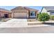 Charming single-story home featuring a well-manicured yard and a two-car garage at 16593 W Alameda Rd, Surprise, AZ 85387