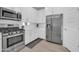 Modern kitchen with stainless steel appliances, white cabinets, and sleek countertops at 16593 W Alameda Rd, Surprise, AZ 85387