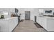 Well-lit kitchen featuring white cabinets, stainless appliances, and spacious countertops at 16593 W Alameda Rd, Surprise, AZ 85387