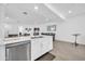 Bright, open kitchen featuring white cabinets, stainless steel appliances, and an island with bar seating at 16593 W Alameda Rd, Surprise, AZ 85387
