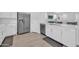 Contemporary kitchen with white cabinetry, stainless steel appliances, and an open design at 16593 W Alameda Rd, Surprise, AZ 85387