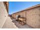 A side yard with a BBQ and tool caddy, covered with gravel and brick pavers and enclosed with a tall block wall at 16593 W Alameda Rd, Surprise, AZ 85387