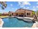 Private backyard oasis featuring a sparkling pool and a covered patio with outdoor seating at 16648 W Adams St, Goodyear, AZ 85338